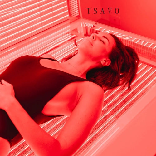 Woman relaxing during a red light therapy session at Tsavo Wellness.
