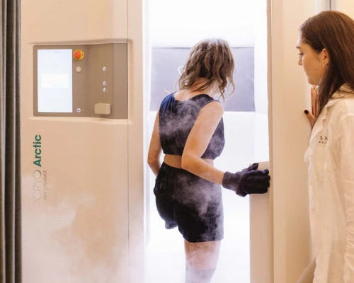 Client stepping into a whole-body cryotherapy chamber at Tsavo Wellness.