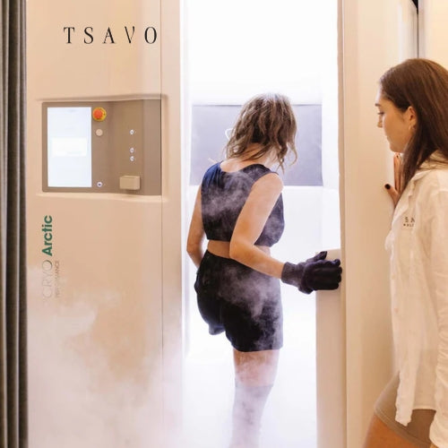 Client stepping into a whole-body cryotherapy chamber at Tsavo Wellness.